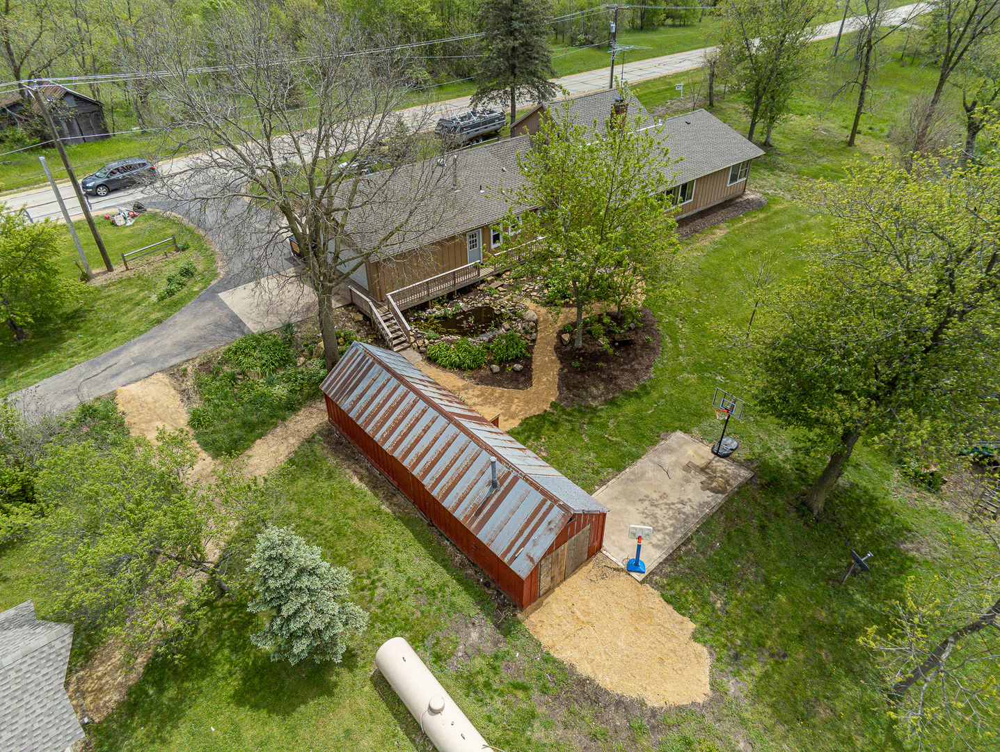 4318 North River Road Byron, IL 61010 - Photo 5 of 28 a view of a backyard with plants and outdoor seating