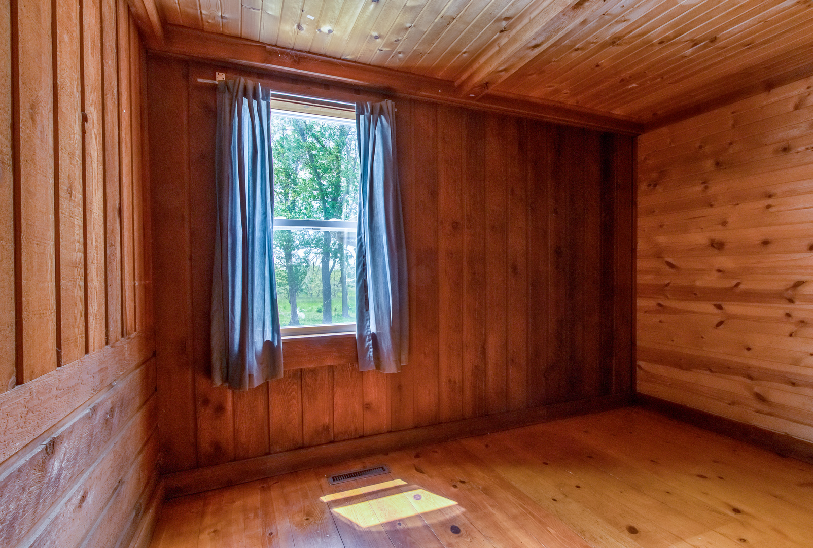 4318 North River Road Byron, IL 61010 - Photo 10 of 28 a view of an empty room with wooden floor and a window