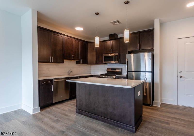 1025 Raritan Road, Unit 303 Clark, NJ 07066 - Photo 14 of 21 a kitchen with stainless steel appliances granite countertop a refrigerator stove a sink and a microwave