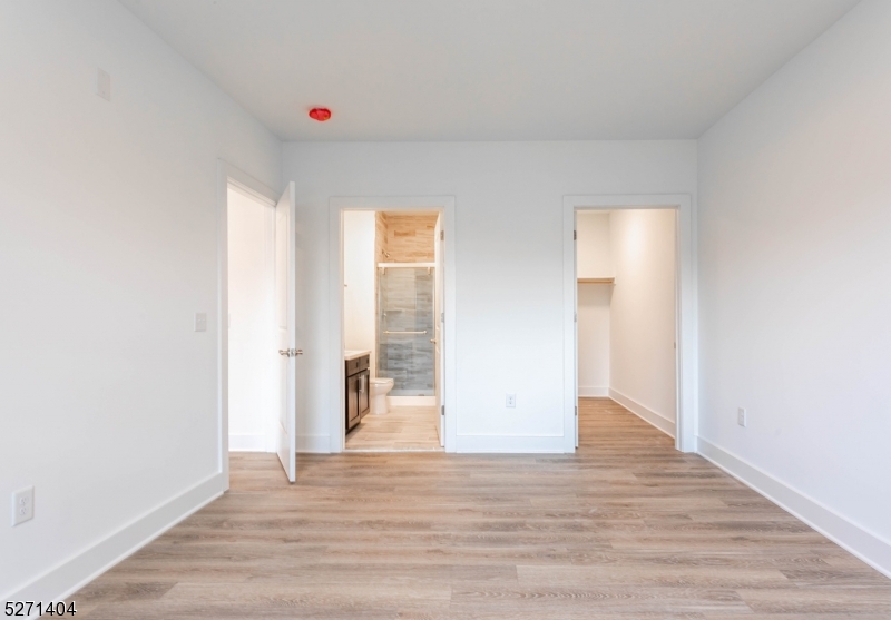 1025 Raritan Road, Unit 303 Clark, NJ 07066 - Photo 15 of 21 a view of an empty room with wooden floor and a window