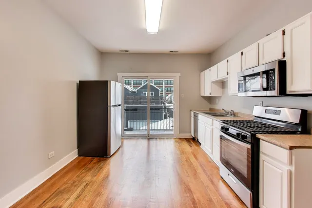 a kitchen with stainless steel appliances granite countertop a refrigerator stove and sink