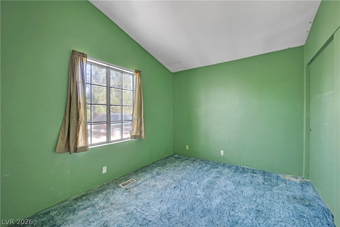 4361 Maple Road Pahrump, NV 89048 - Photo 24 of 46 A quiet space with vaulted ceilings and a window overlooking lush greenery.