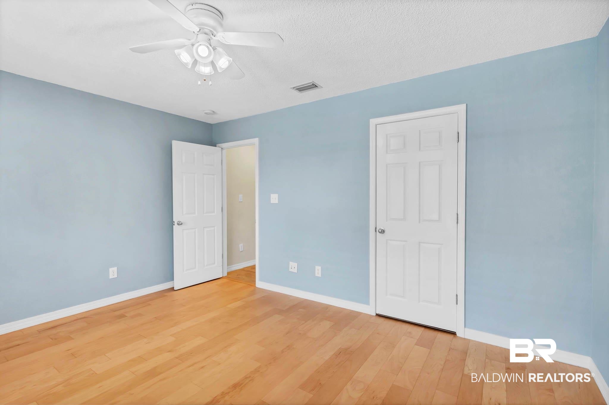 9607 Czar Court Fairhope, AL 36532 - Photo 24 of 42 Unfurnished bedroom featuring light wood-style floors, ceiling fan, and a textured ceiling