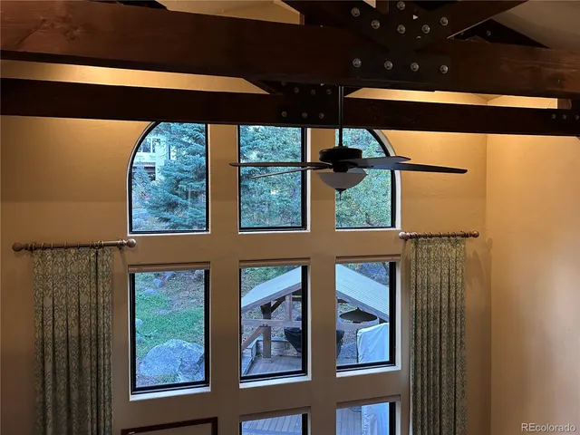 a view of an empty room with furniture and a fireplace