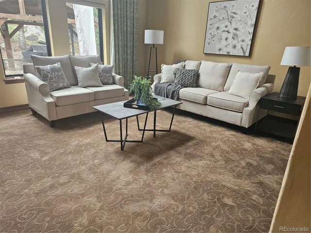 a living room with furniture and a large window