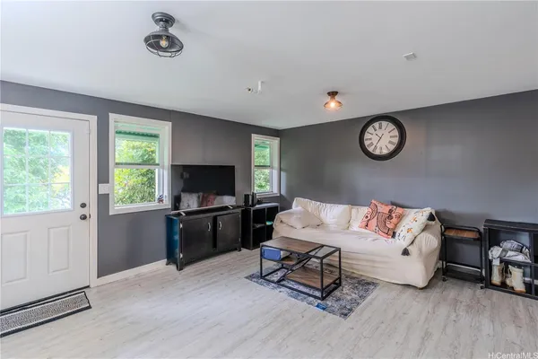 a bedroom with a bed and a lamp on dresser