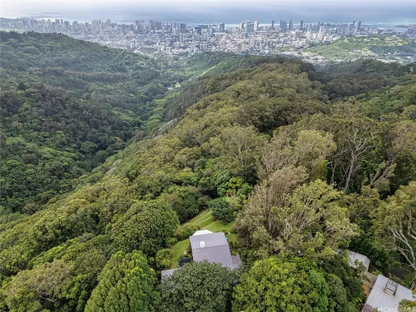 a living room with furniture a fireplace and large windows