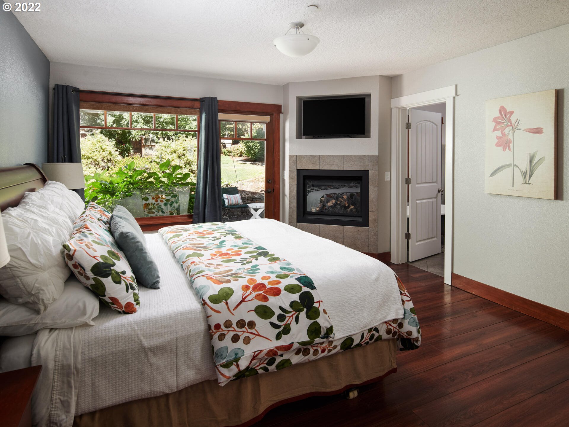 4825 Southwest Evans Street Portland, OR 97219 - Photo 14 of 32 a bedroom with a bed and a fireplace