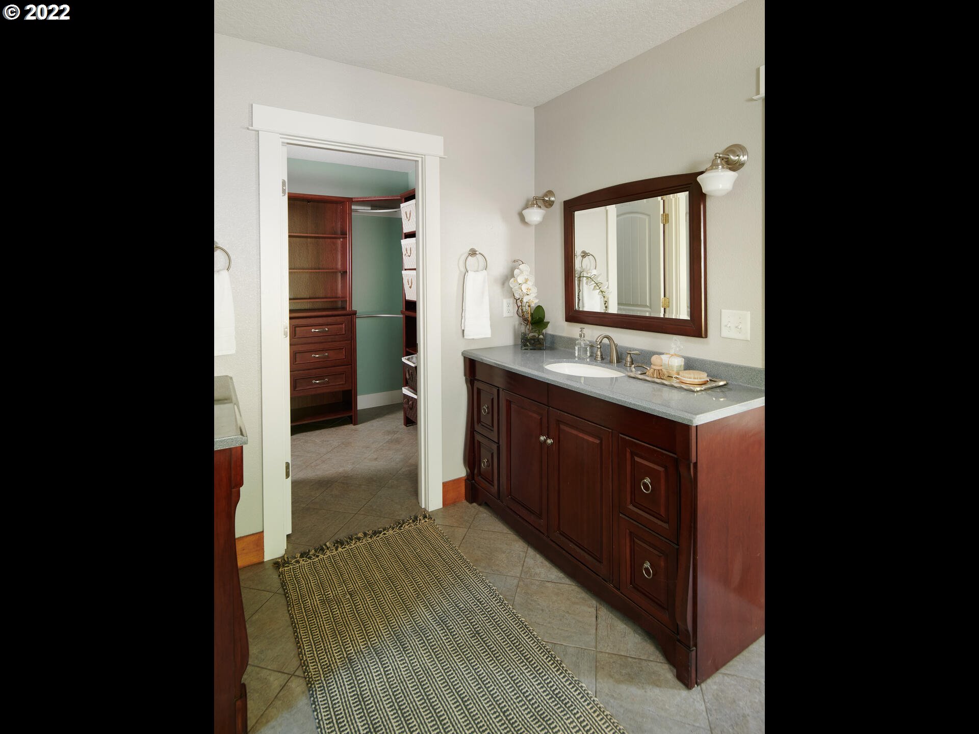 4825 Southwest Evans Street Portland, OR 97219 - Photo 16 of 32 a bathroom with a granite countertop sink mirror and cabinets