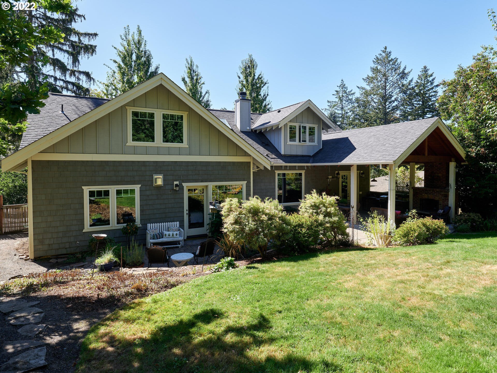 4825 Southwest Evans Street Portland, OR 97219 - Photo 22 of 32 a front view of a house with a yard and porch