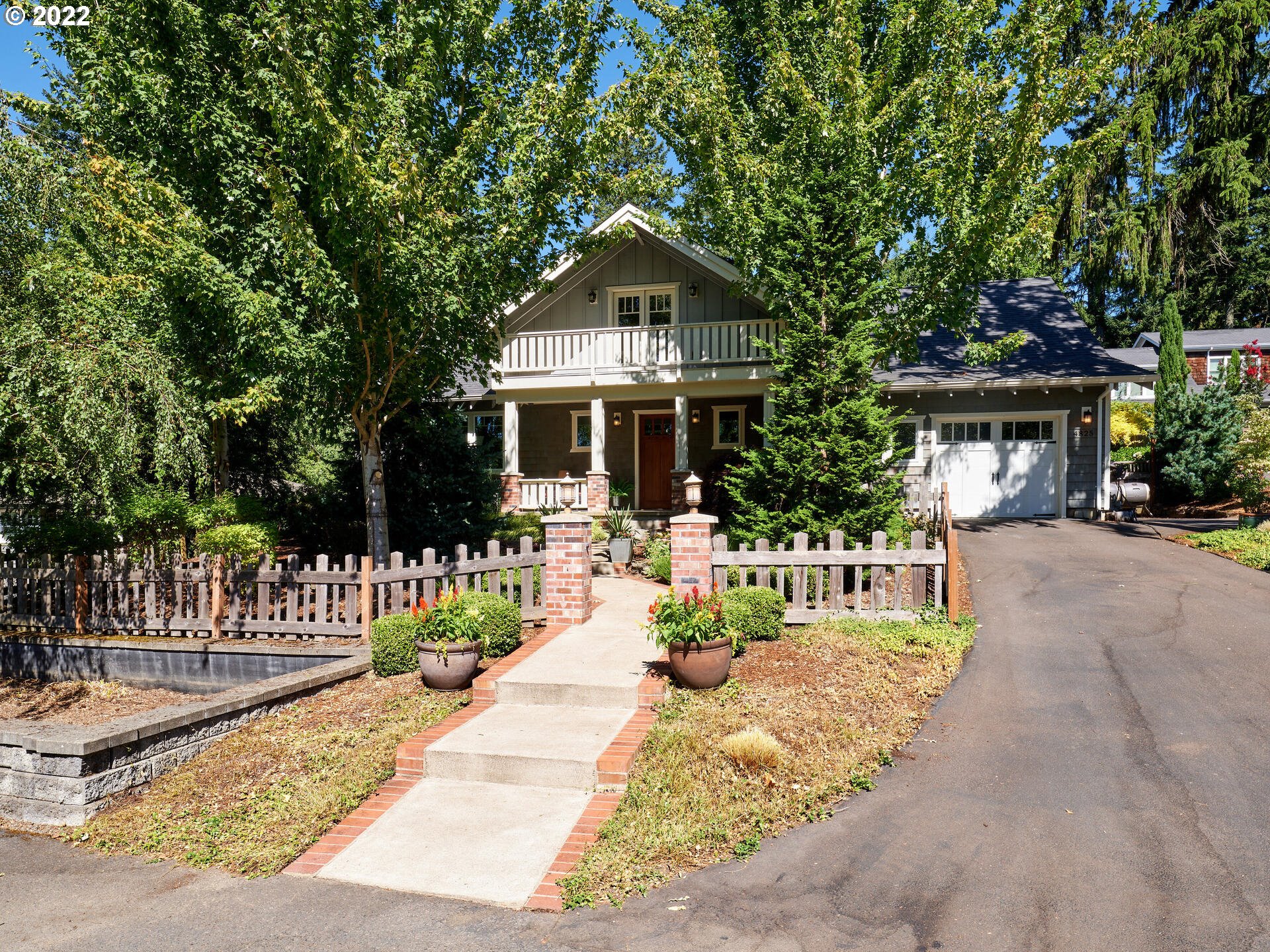 4825 Southwest Evans Street Portland, OR 97219 - Photo 3 of 32 a front view of a house with a yard