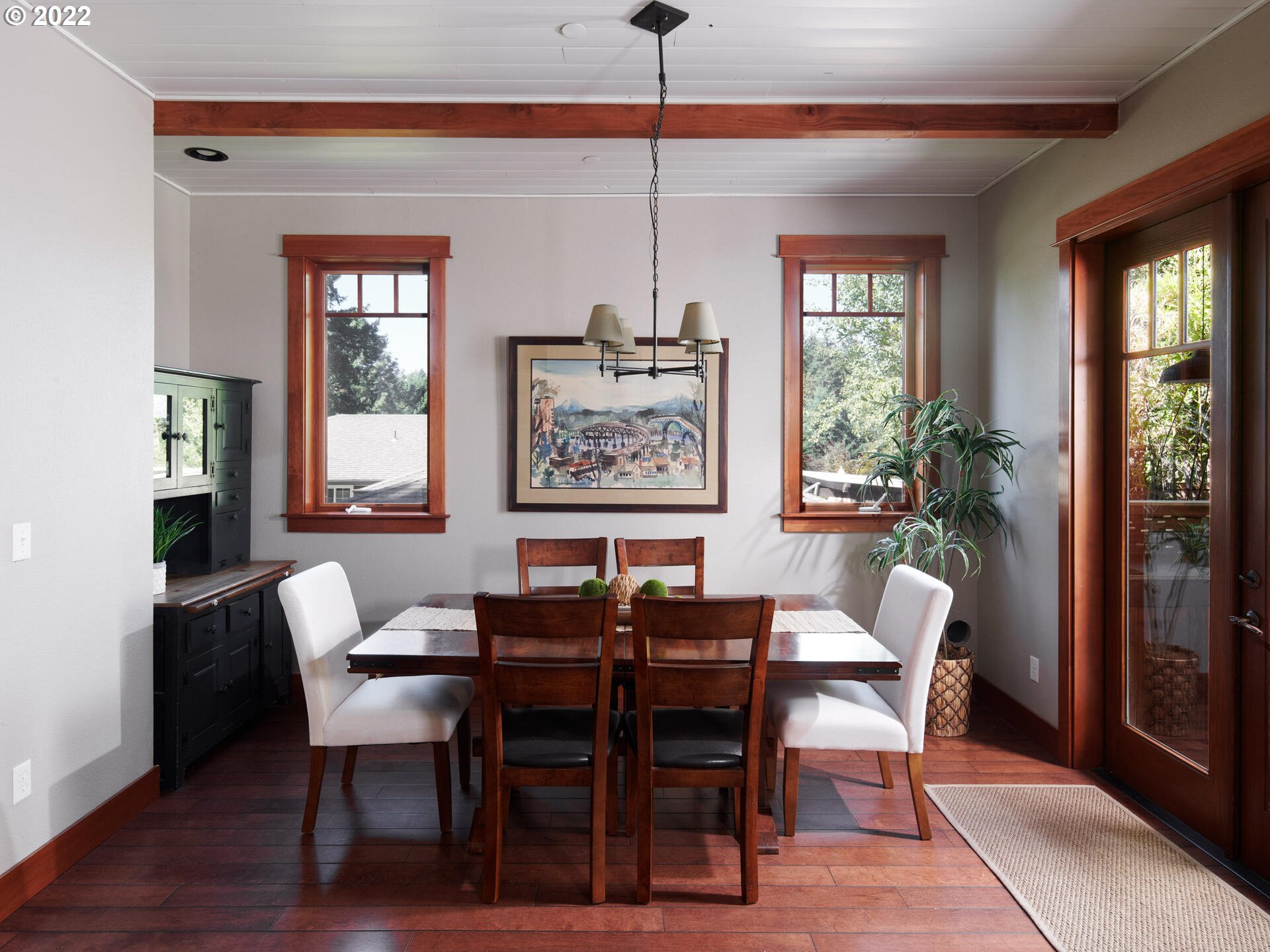 4825 Southwest Evans Street Portland, OR 97219 - Photo 8 of 32 a dining room with furniture a chandelier and wooden floor