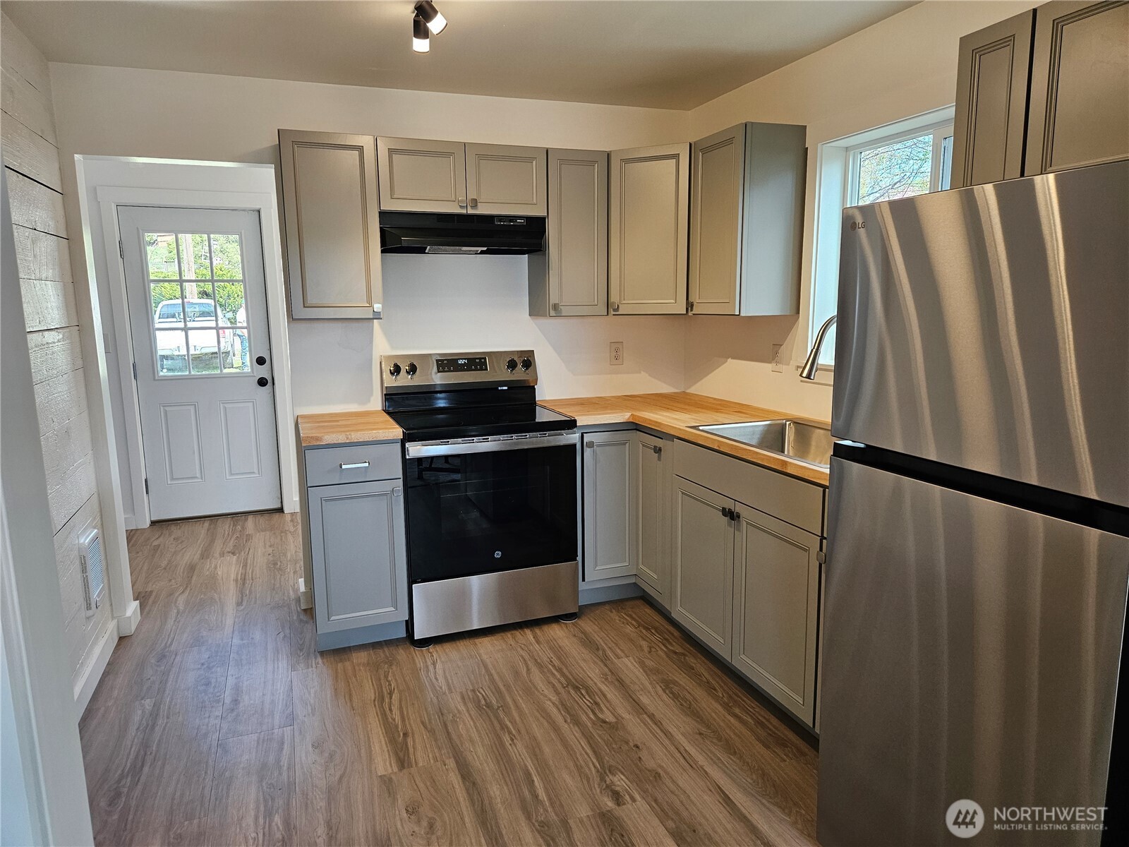 108 West 3rd Street Lind, WA 99341 - Photo 13 of 29 a kitchen with stainless steel appliances a refrigerator stove and sink