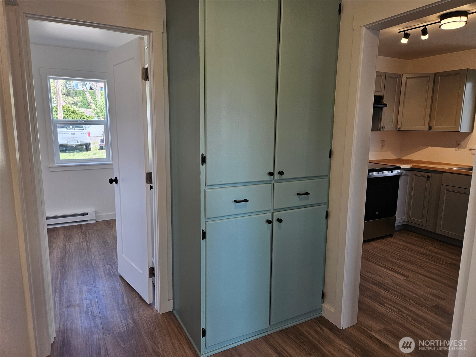 108 West 3rd Street Lind, WA 99341 - Photo 15 of 29 a view of a hallway with wooden floor and a bathroom