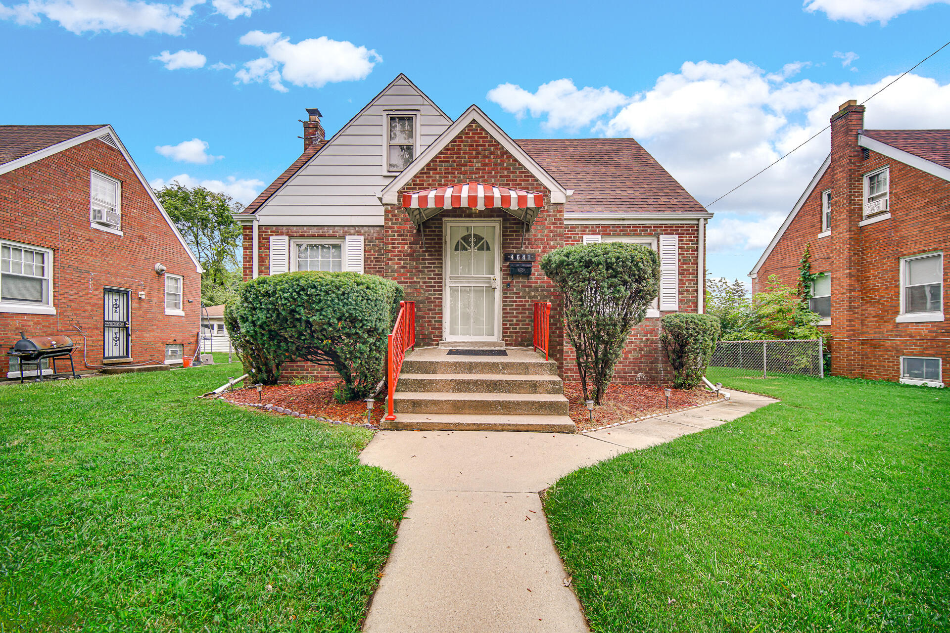 4641 Delaware Street Gary, IN 46409 - Photo 1 of 22 a front view of a house with garden and plants