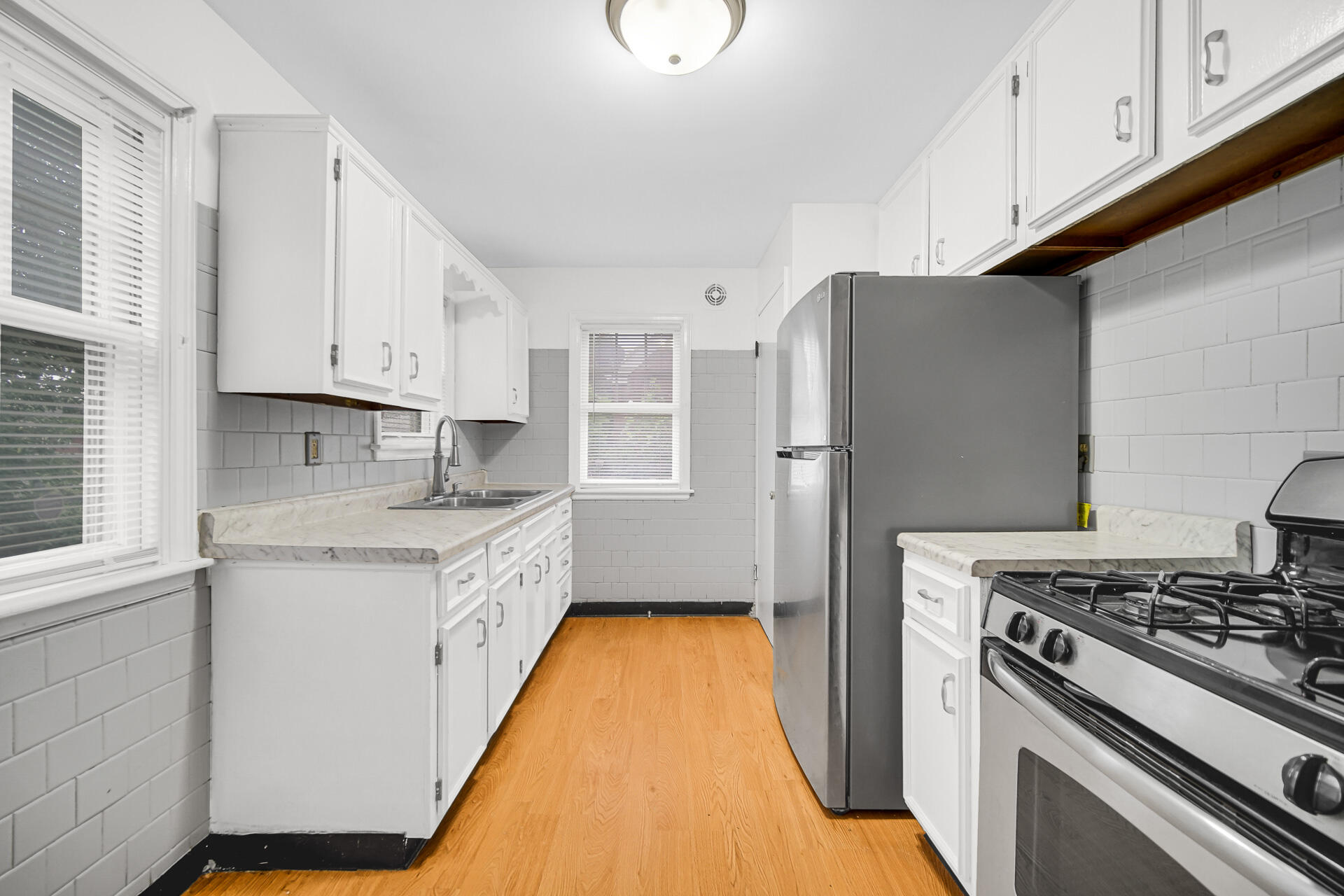 4641 Delaware Street Gary, IN 46409 - Photo 12 of 22 a kitchen with stainless steel appliances granite countertop a stove a refrigerator and a sink