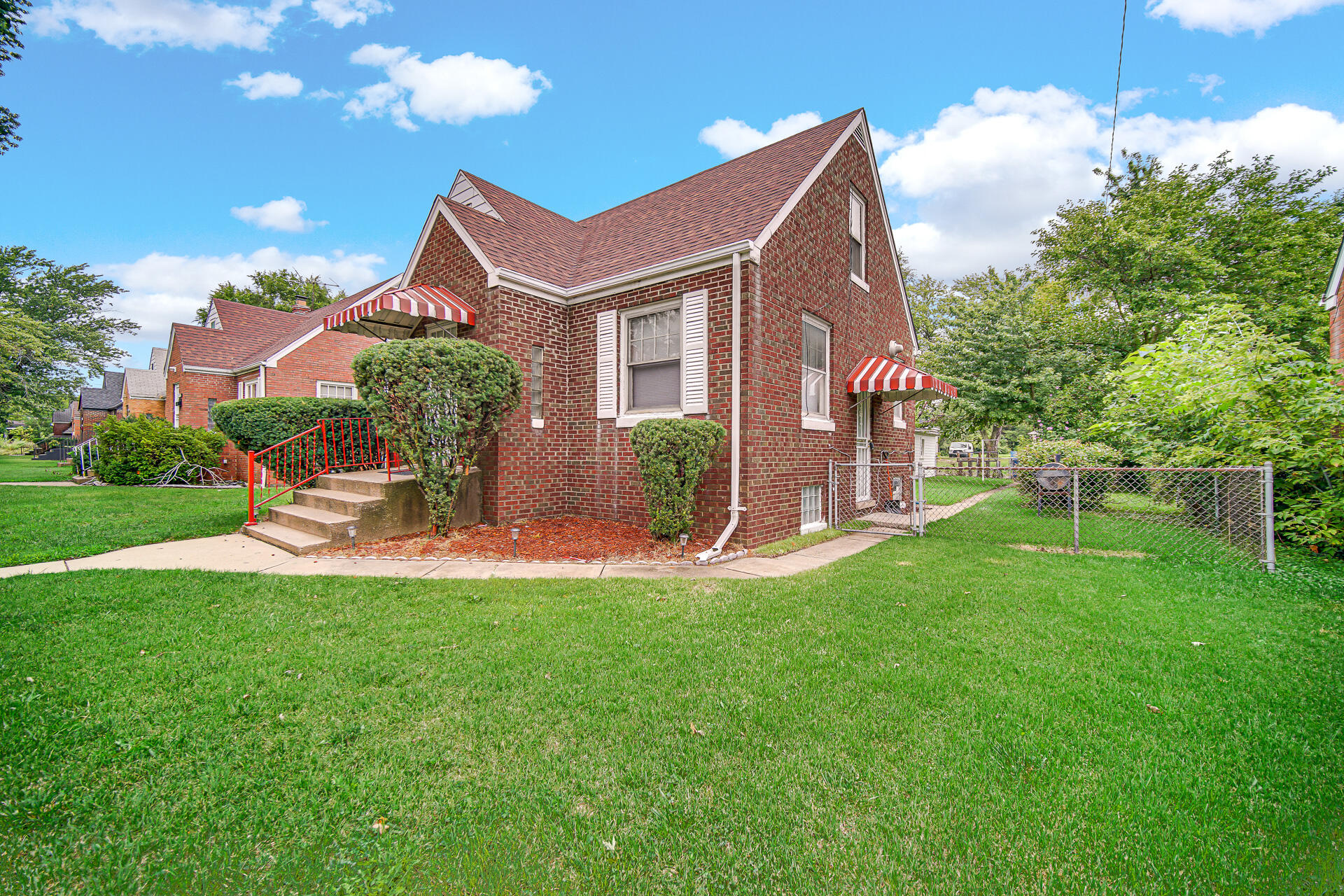 4641 Delaware Street Gary, IN 46409 - Photo 2 of 22 a front view of a house with a garden and yard