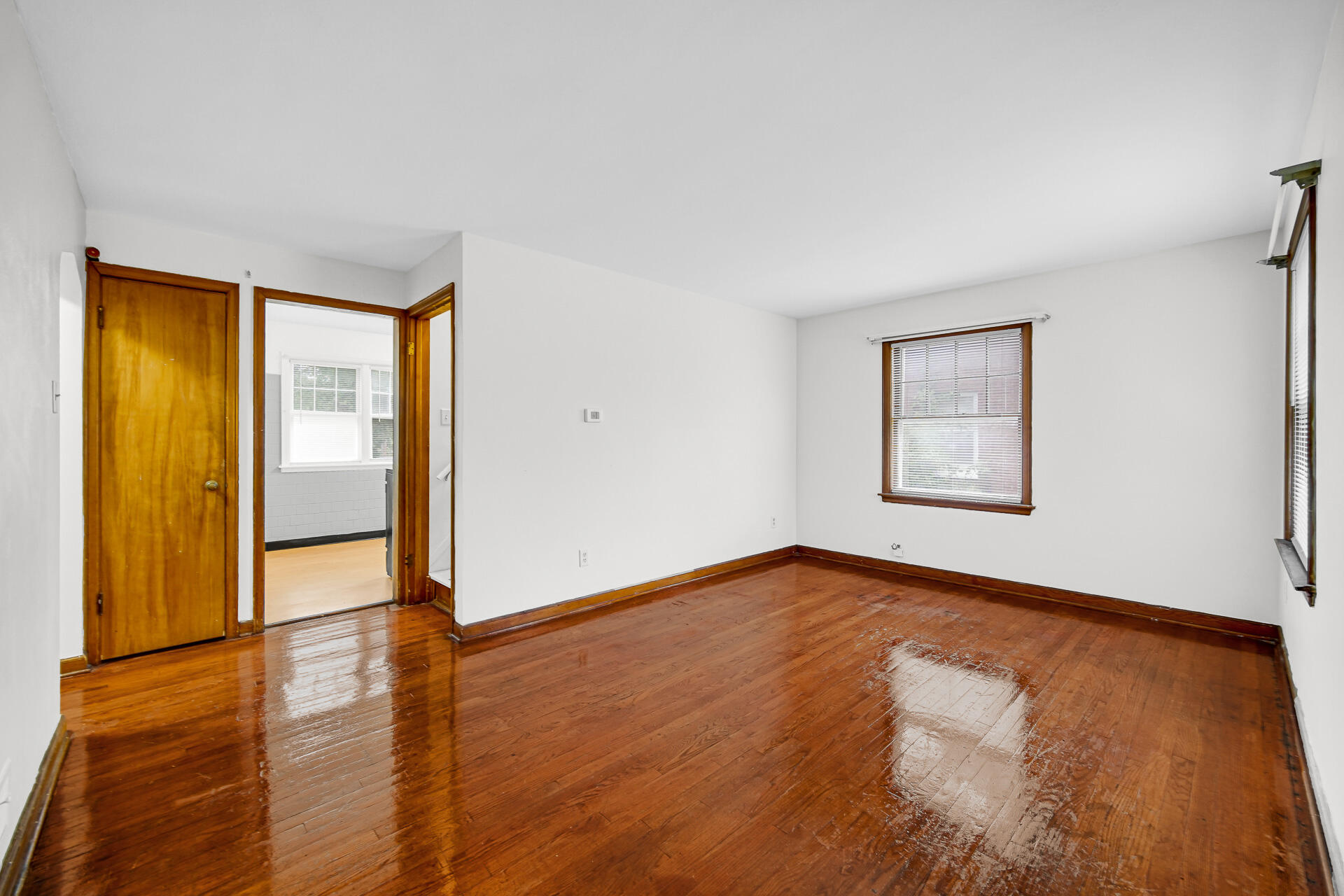 4641 Delaware Street Gary, IN 46409 - Photo 3 of 22 an empty room with wooden floor and windows