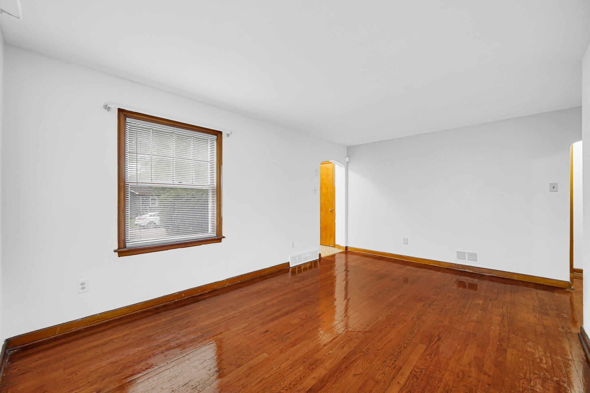 4641 Delaware Street Gary, IN 46409 - Photo 4 of 22 an empty room with wooden floor and windows