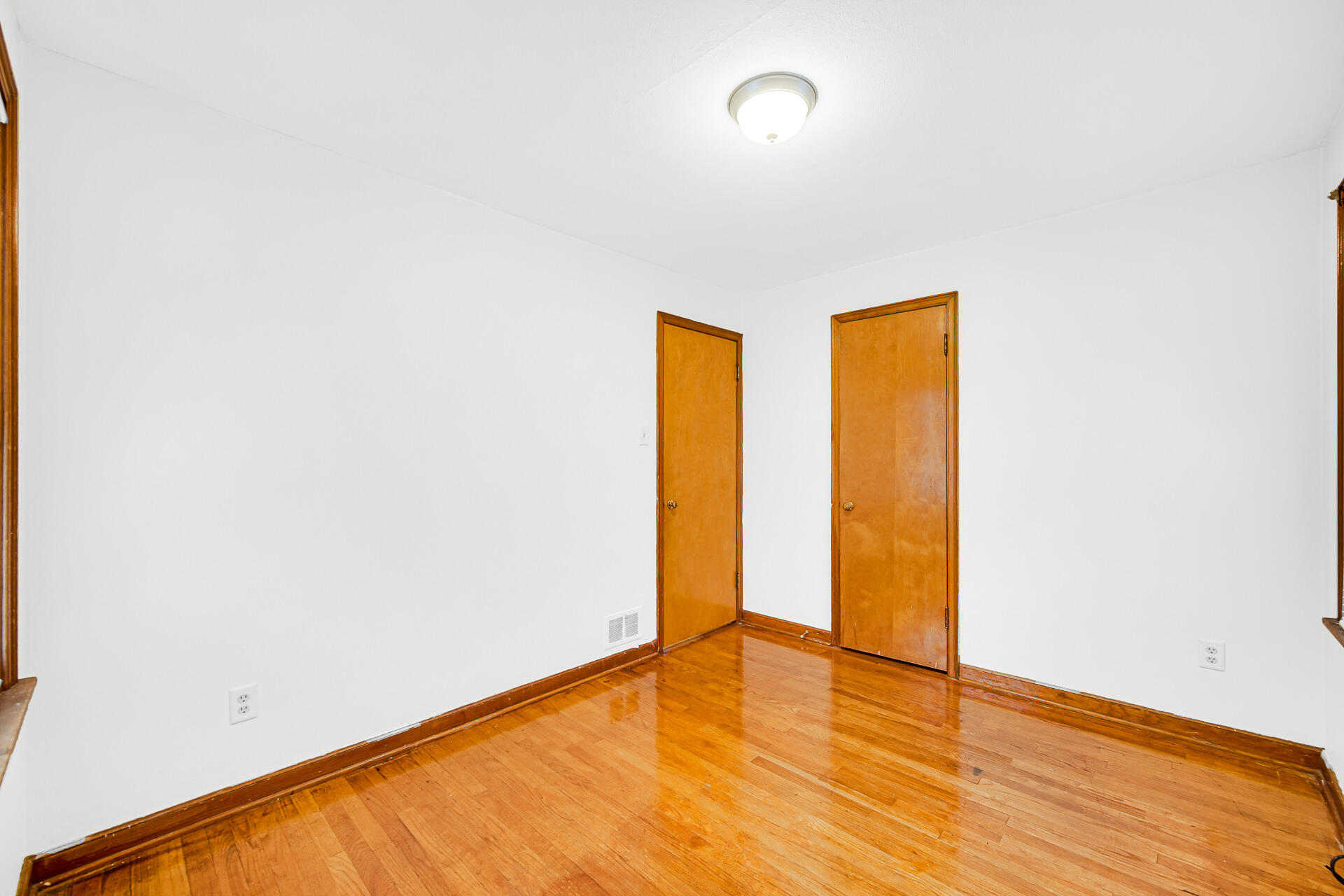 4641 Delaware Street Gary, IN 46409 - Photo 7 of 22 a view of empty room with wooden floor and fence