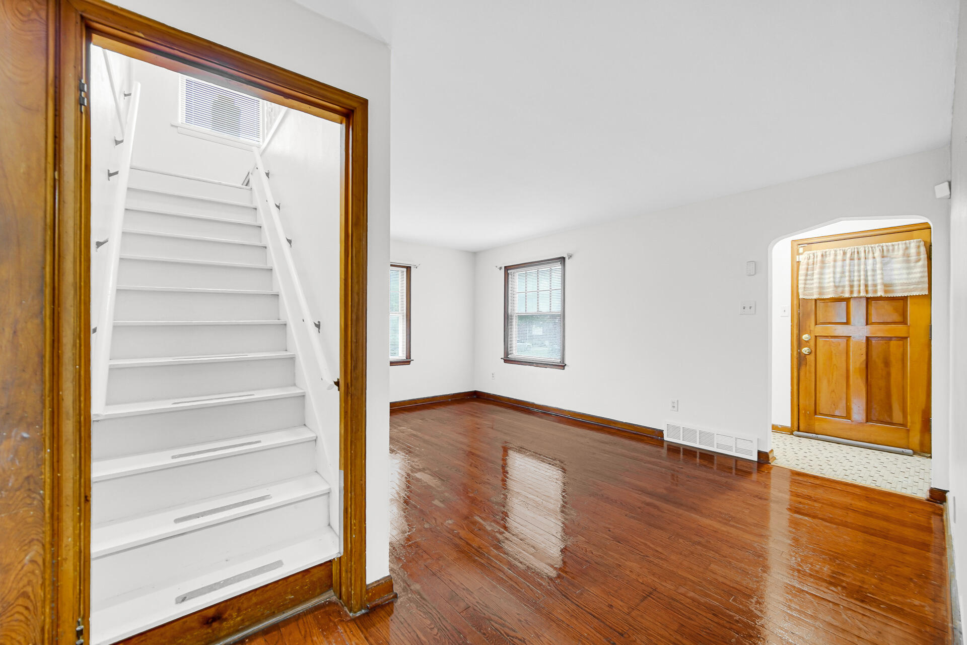 4641 Delaware Street Gary, IN 46409 - Photo 8 of 22 a view of an empty room with wooden floor and a window