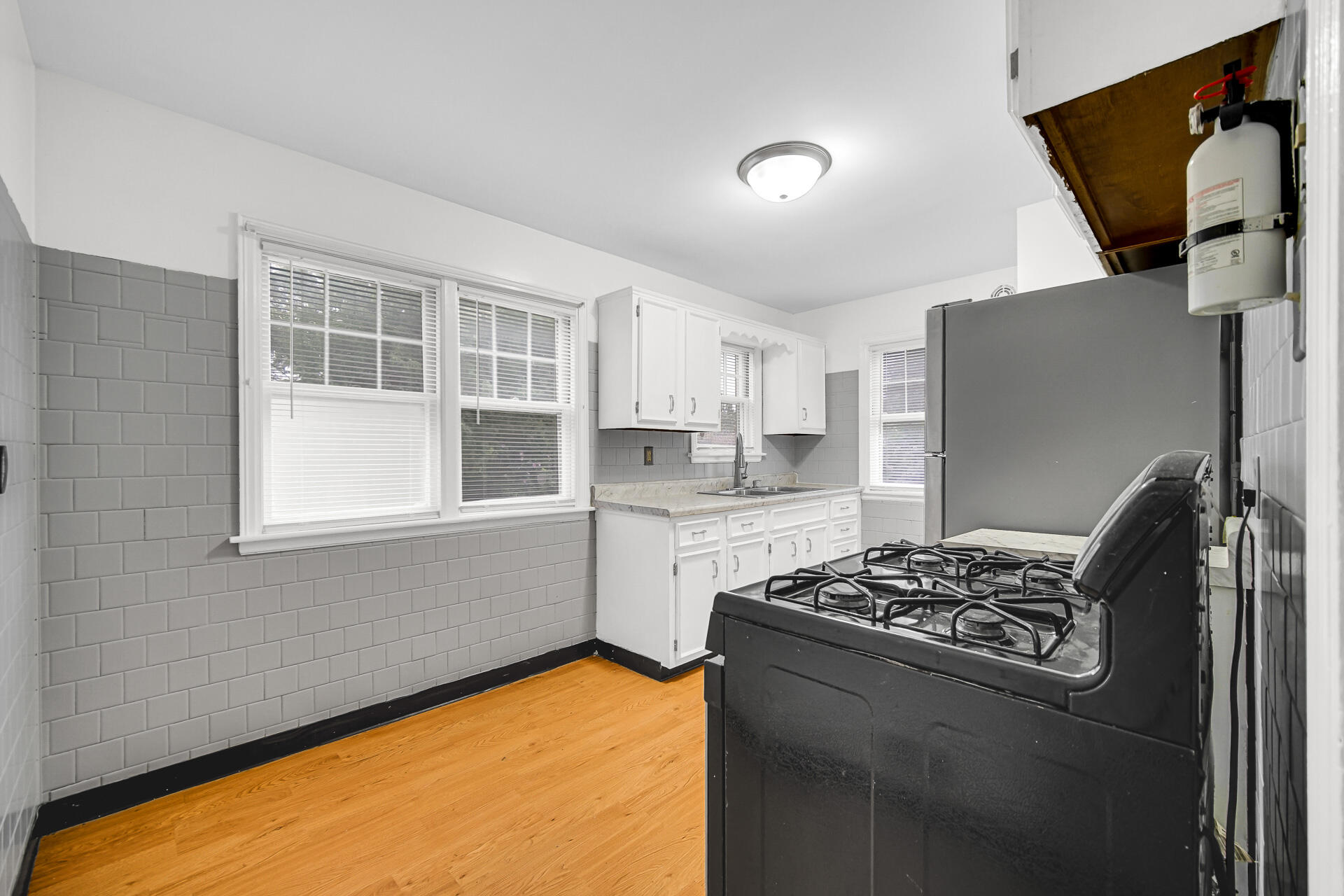 4641 Delaware Street Gary, IN 46409 - Photo 10 of 22 a kitchen with a stove a refrigerator and a sink