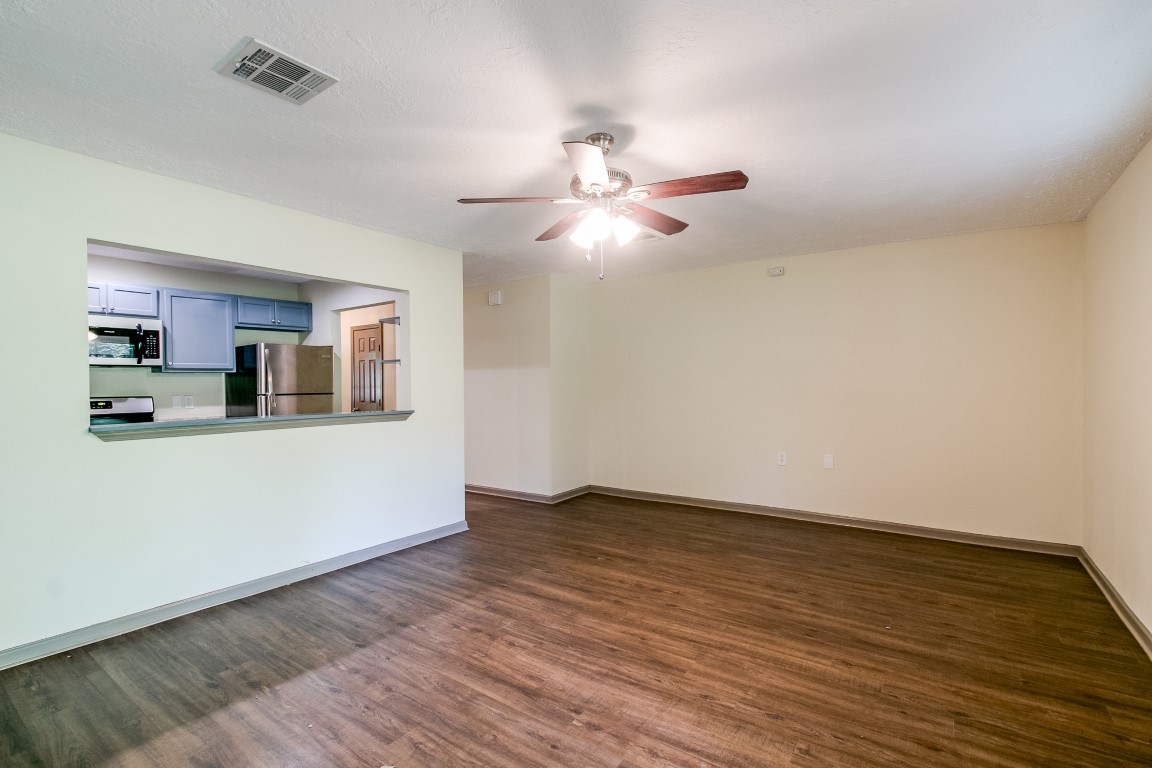 24615 Wilderness Road Spring, TX 77380 - Photo 12 of 34 a view of a kitchen with wooden floor and a ceiling fan