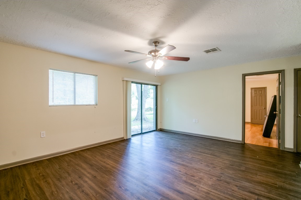24615 Wilderness Road Spring, TX 77380 - Photo 14 of 34 a view of an empty room with window and wooden floor