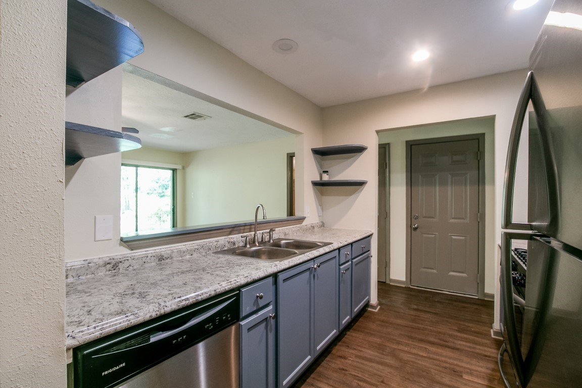 24615 Wilderness Road Spring, TX 77380 - Photo 16 of 34 a bathroom with a granite countertop sink and a mirror