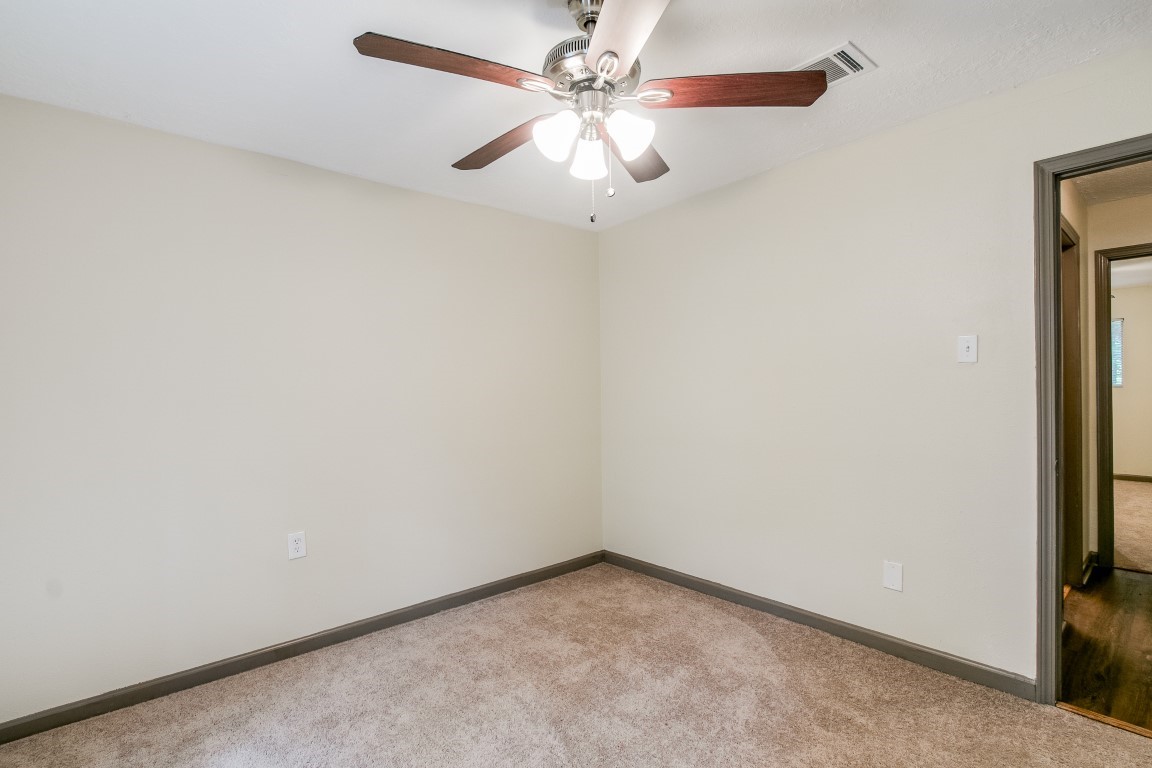24615 Wilderness Road Spring, TX 77380 - Photo 18 of 34 an empty room with a fan and a ceiling fan