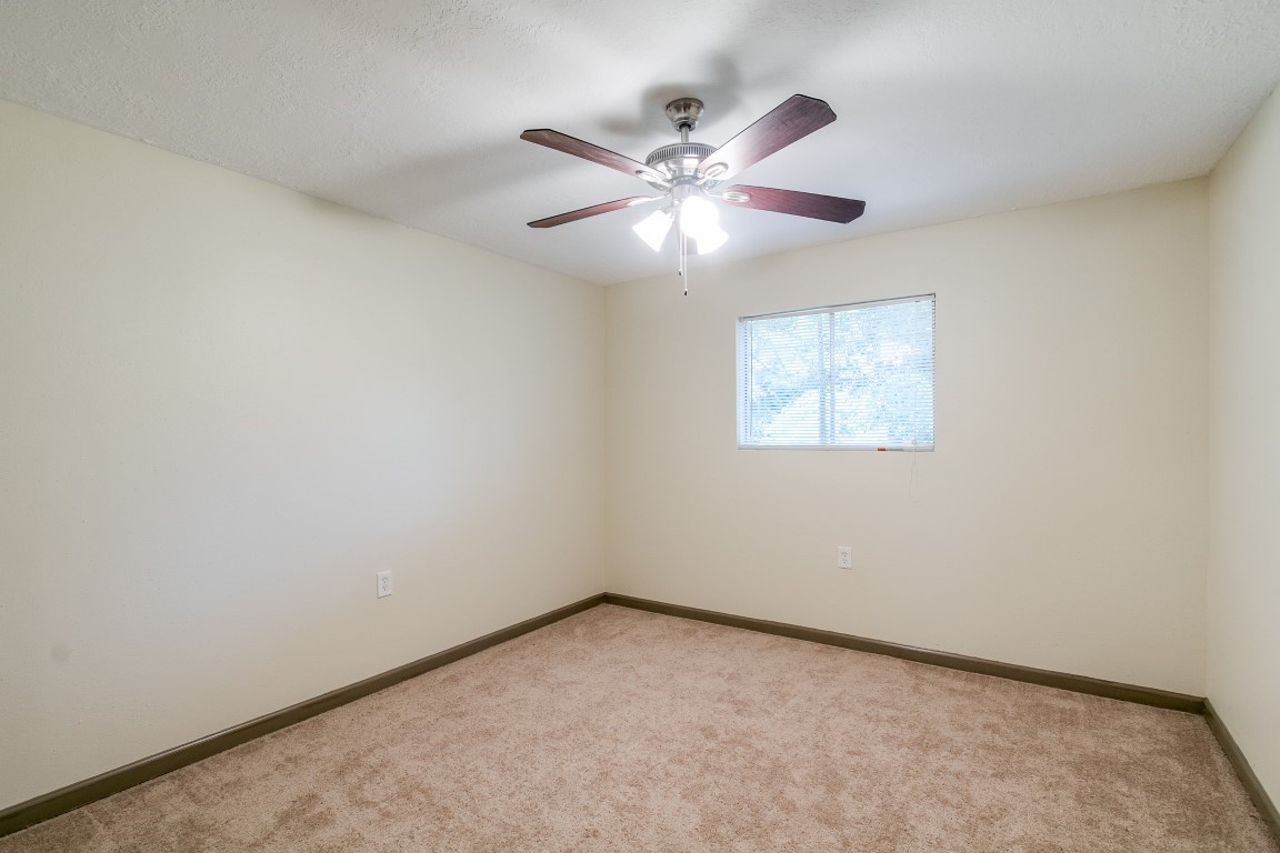 24615 Wilderness Road Spring, TX 77380 - Photo 23 of 34 an empty room with a window and a fan