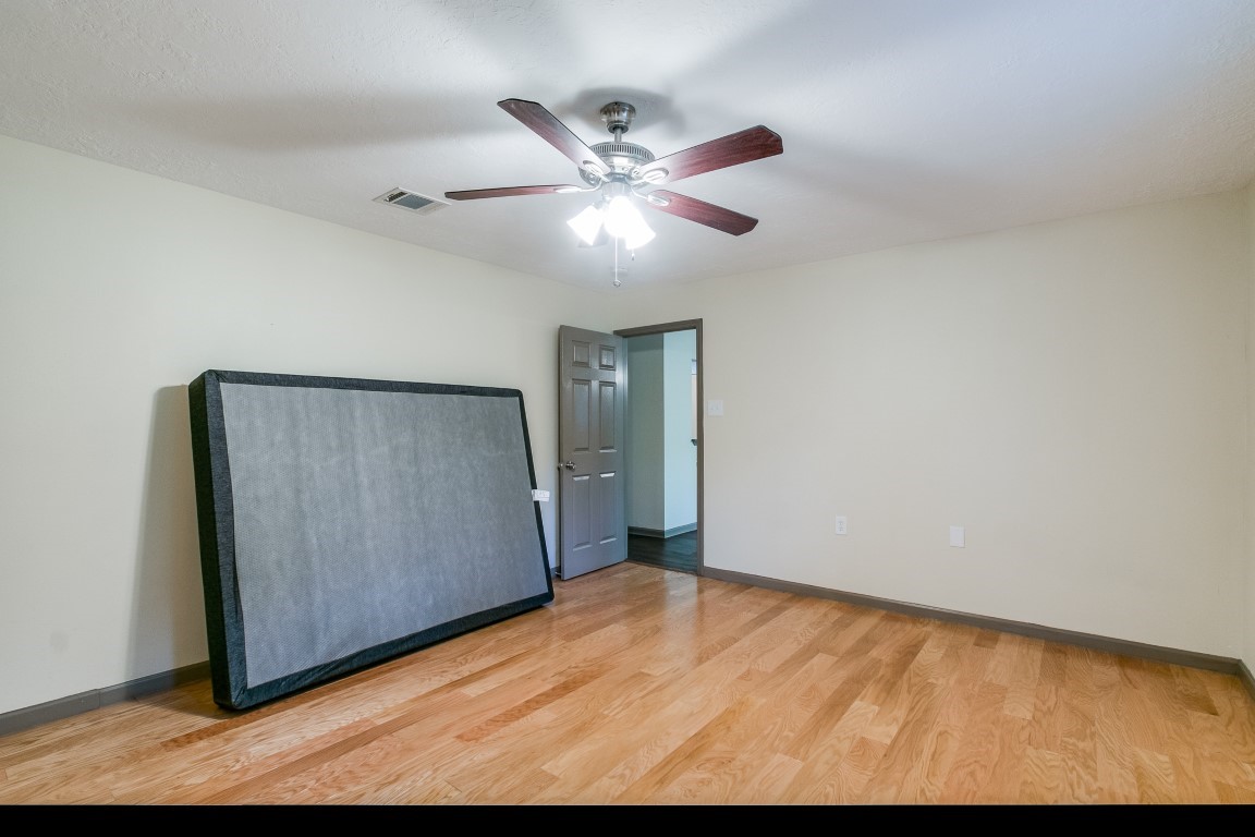 24615 Wilderness Road Spring, TX 77380 - Photo 29 of 34 a view of empty room with wooden floor