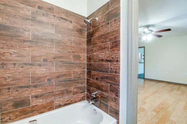 a bathroom with a bathtub and shower