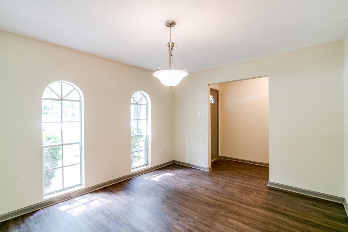 24615 Wilderness Road Spring, TX 77380 - Photo 7 of 34 an empty room with wooden floor and windows