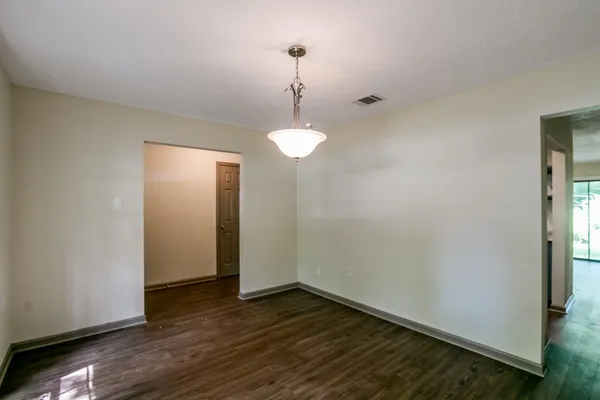 a view of a room with wooden floor and windows
