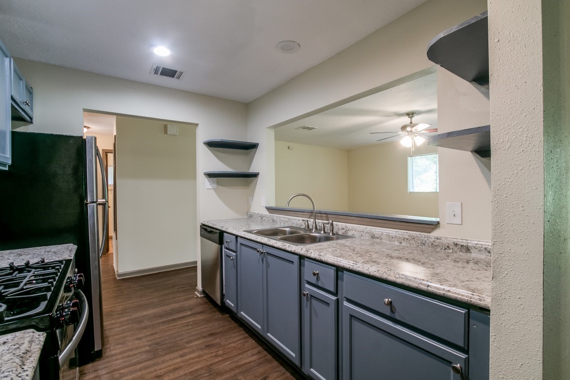 24615 Wilderness Road Spring, TX 77380 - Photo 9 of 34 a kitchen with a sink and a refrigerator