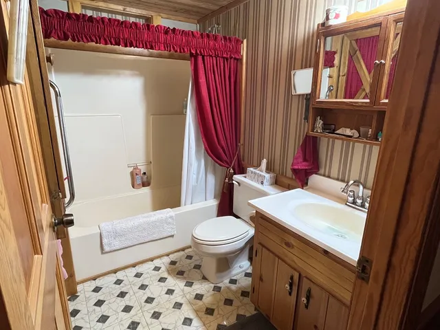 a bedroom with a bed and a mirror