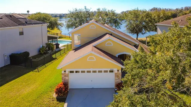 a view of a dining room with furniture a chandelier and wooden floor