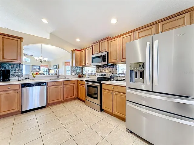 a room with furniture a flat screen tv and a window
