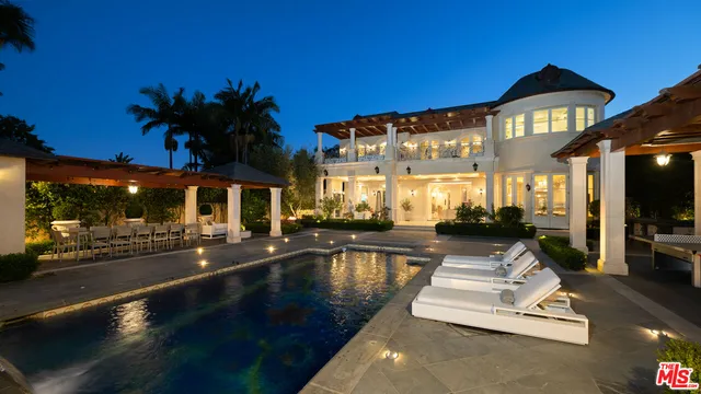 a view of a building with swimming pool and sitting area
