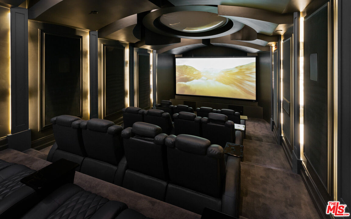 718 North Rodeo Drive Beverly Hills, CA 90210 - Photo 39 of 51 a living room with furniture and a flat screen tv