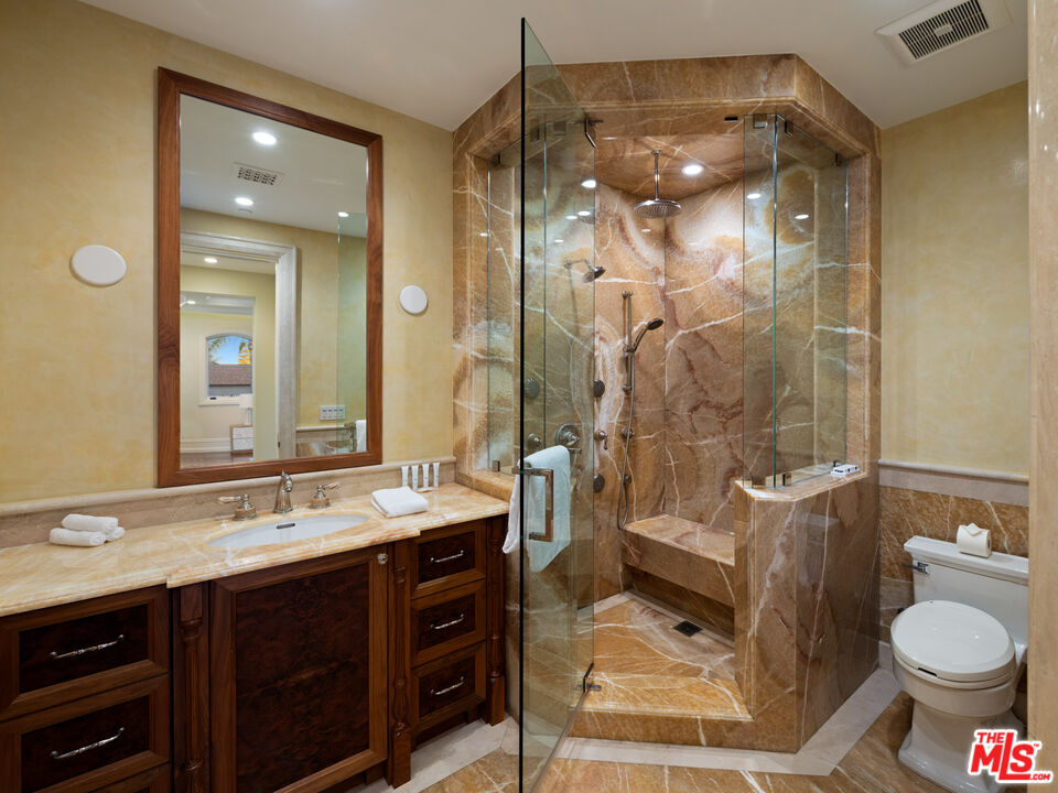 718 North Rodeo Drive Beverly Hills, CA 90210 - Photo 43 of 51 a bathroom with a double vanity sink toilet mirror and shower