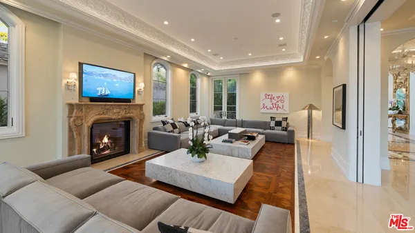 a living room with furniture a large window and a fireplace