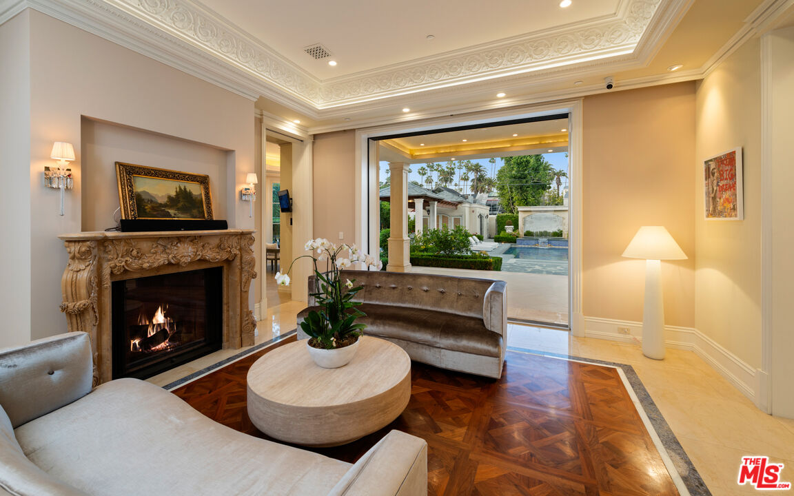 718 North Rodeo Drive Beverly Hills, CA 90210 - Photo 9 of 51 a living room with furniture a large window and a fireplace