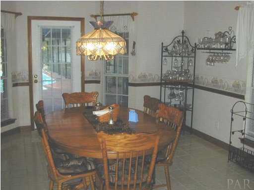 5004 Roland Road Pace, FL 32571 - Photo 2 of 13 a view of a dining room with furniture and chandelier