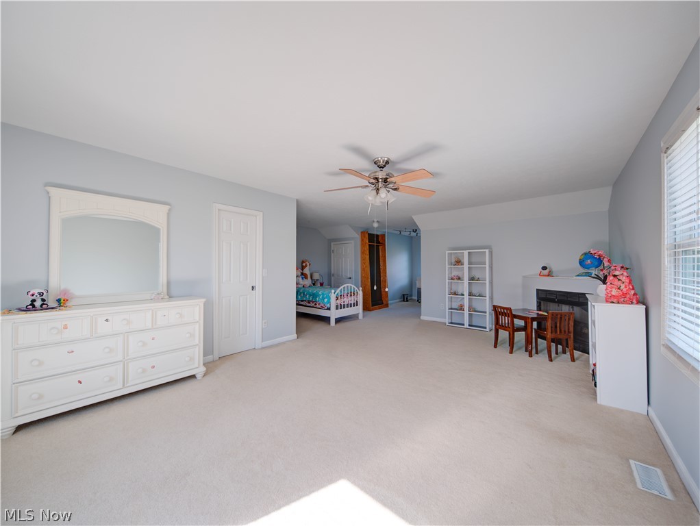 9900 Mentor Road Chardon, OH 44024 - Photo 33 of 49 Game room with light carpet, ceiling fan, and a healthy amount of sunlight