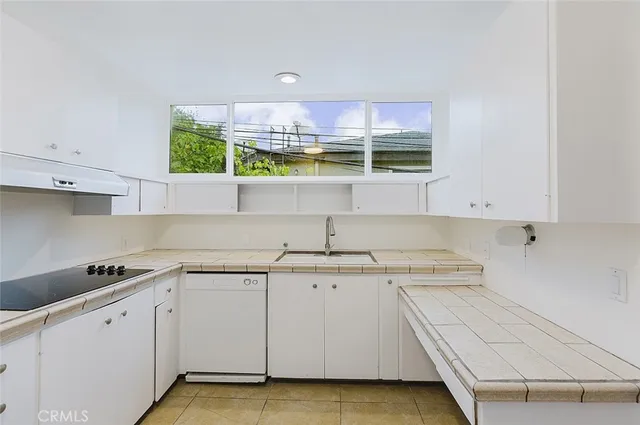 a kitchen with stainless steel appliances granite countertop a sink and a stove