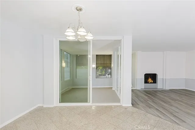 a view of a livingroom with a chandelier fan and fire place