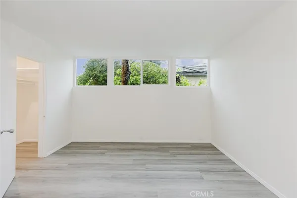 a view of room with wooden floor and window