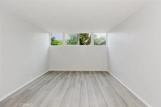 a view of room with window and wooden floor